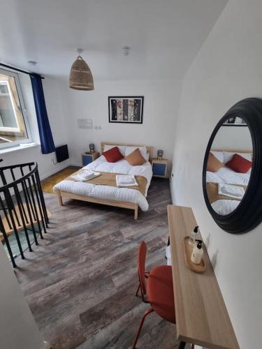 a living room with a couch and a mirror at New ground floor city centre apartment in Hull