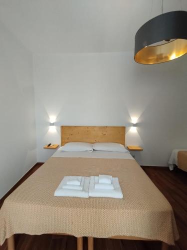 a bedroom with a bed with two towels on it at Ravanas 33 in Bari