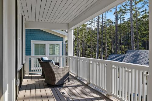 a porch with a wicker chair on a house at Solitude by Seabrook Hospitality in Pacific Beach