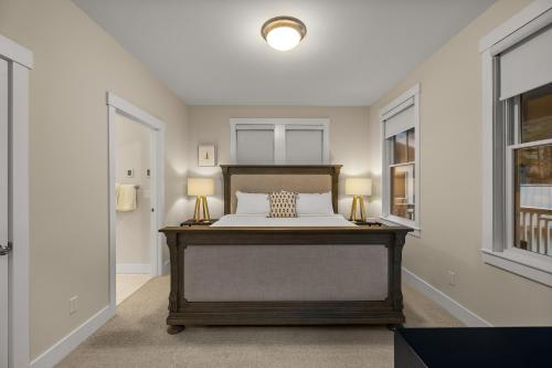 a bedroom with a bed with two lamps on it at Solitude by Seabrook Hospitality in Pacific Beach