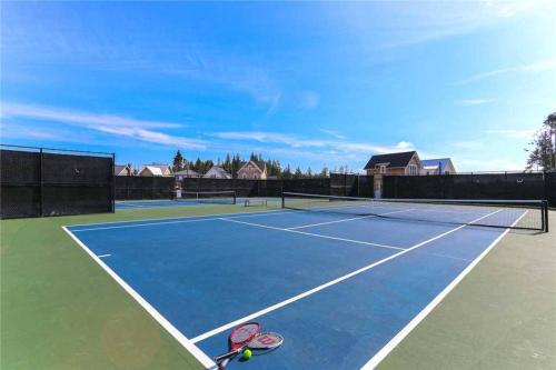 a tennis court with two tennis rackets on it at Solitude by Seabrook Hospitality in Pacific Beach