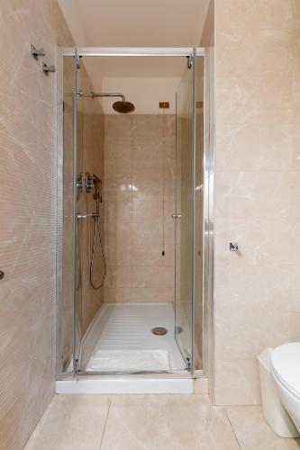 a shower with a glass door in a bathroom at Napolit'amo Hotel Principe in Naples