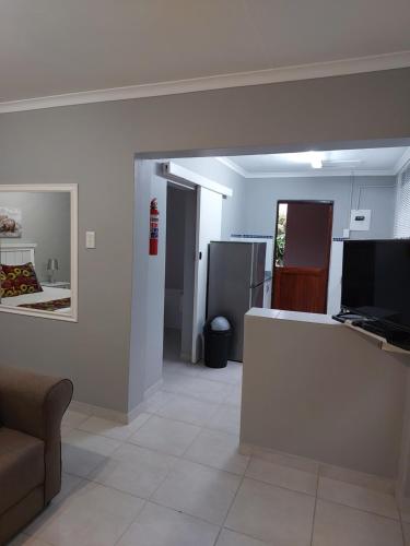 a living room with a counter and a kitchen at Fairway Guest Lodge in Margate