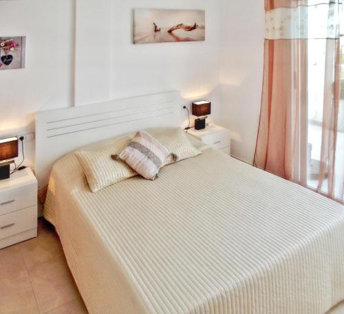 a bedroom with a large bed with two pillows at 2 bedrooms apartement at Vinaros 100 m away from the beach with sea view shared pool and furnished terrace in Vinarós