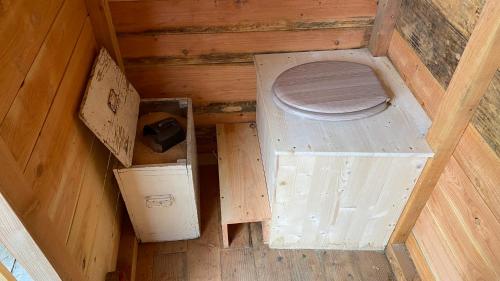 an overhead view of a toilet in a wooden house at Le jardin secret in Semur-en-Auxois