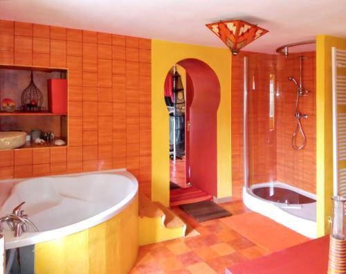 a large bathroom with a tub and a shower at Appartement de 2 chambres avec terrasse amenagee et wifi a Chenevrey et Morogne in Chenevrey-et-Morogne