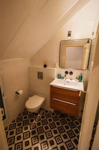 a bathroom with a sink and a toilet and a mirror at Nice Studio - Top location in Jerusalem