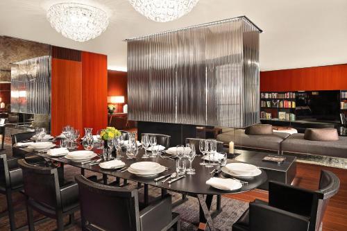 a dining room with a table and chairs and a couch at Bvlgari Hotel London in London