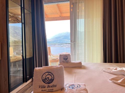 a hotel room with a bed with two boxes on it at Villa Bodini Himare in Himare