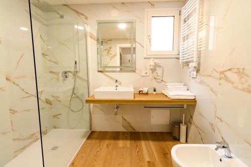 a bathroom with a sink and a shower at Harbor Rooms - Cala Gonone in Cala Gonone