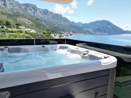 a hot tub on a balcony with a view of the ocean at Villa Laganini Apartment 2&4 in Podaca