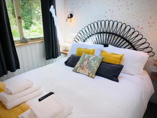 a white bed with pillows and towels on it at The Apple Inn in Lucker