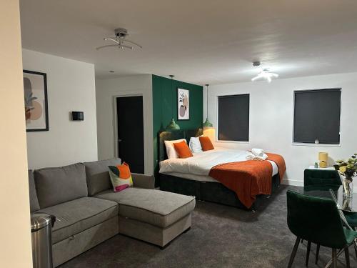 a hotel room with a bed and a couch at Midsummer House Apartments "Free On-Site Parking & Sky TV" in Peterborough