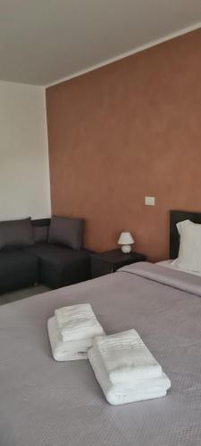 a bedroom with a bed with two towels on it at Pensiunea Danubio in Dunavăţu de Jos