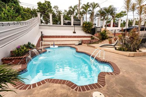 a small swimming pool in a yard with a house at Enjoy Rare Huge POOL 4br Perfect for Families! in Aguada