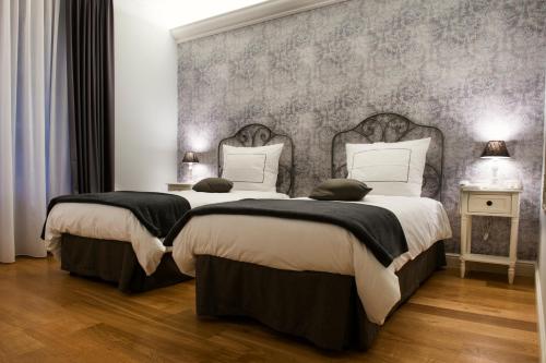 a bedroom with two beds and a wall at Maralè in Serino