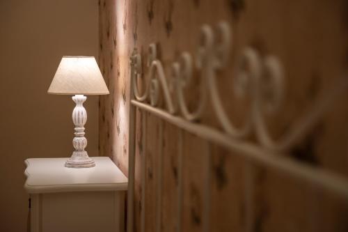 a lamp sitting on a table next to a wall at Maralè in Serino