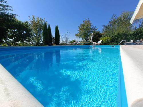 a swimming pool with blue water in a house at Villa Lara in Marsaglia