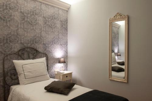 a bedroom with a bed and a mirror at Maralè in Serino