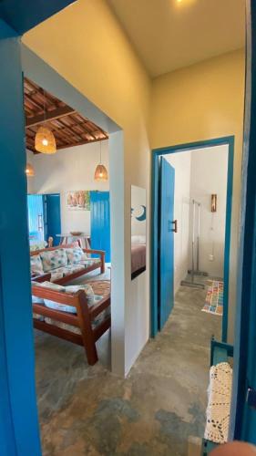 a room with two beds and a mirror at Pousada Vila Lua Bela in Pitimbu