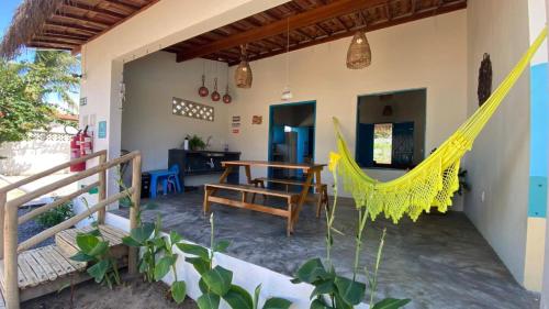 a hammock in the living room of a house at Pousada Vila Lua Bela in Pitimbu