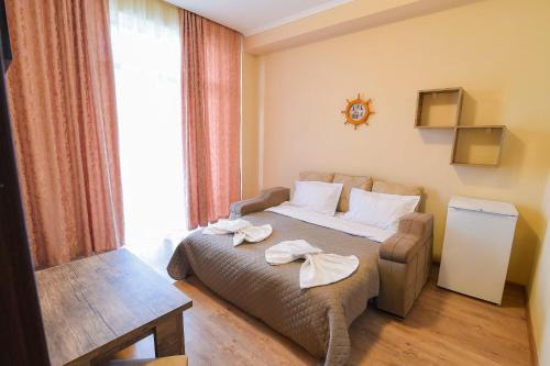 a hotel room with a bed and a window at Hotel Shaori in Nikortsminda