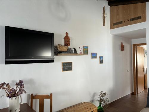 a living room with a flat screen tv on a wall at CasinhaD'Alice in Reguengos de Monsaraz