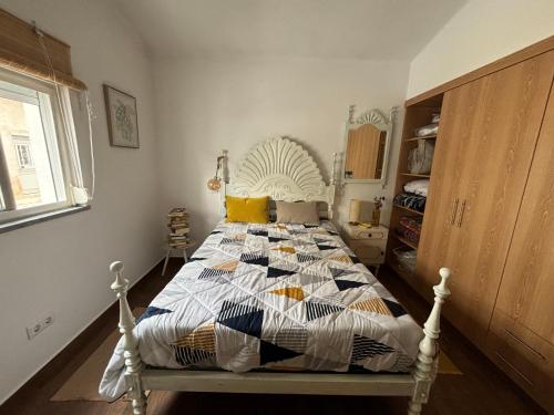 a bedroom with a bed with a quilt on it at CasinhaD'Alice in Reguengos de Monsaraz