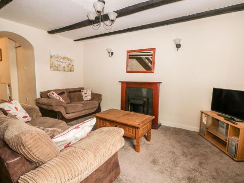a living room with two couches and a television at Rose in Filey