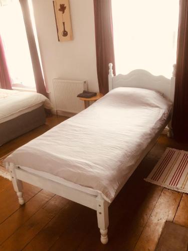 a white bed in a room with a window at Hope & Anchor, Hadrian's Wall, Port Carlisle, Solway Firth, Area of Natural Beauty in Port Carlisle