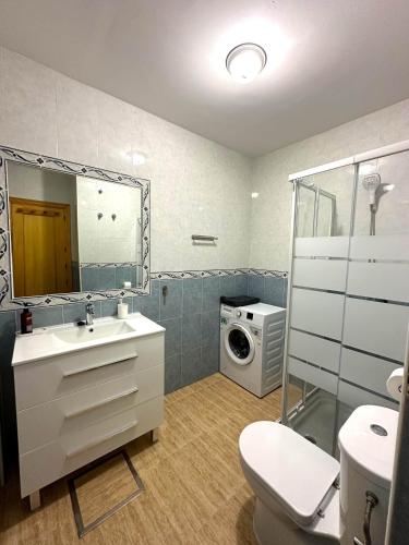 a bathroom with a sink and a washing machine at Sea Estudio Cala de Mijas in La Cala de Mijas