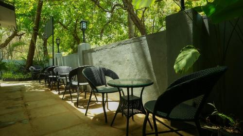 a row of chairs and tables in a patio at Sort By Stays, Grand Peddem, Anjuna in Goa