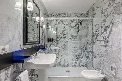 a bathroom with a sink and a shower at Room Mate Luca, Florence in Florence