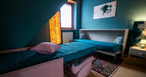 a bedroom with two beds and a window at BOSSEMA 8 Home in Calmasino