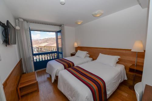 Postel nebo postele na pokoji v ubytování Hotel Plaza de Armas Cusco
