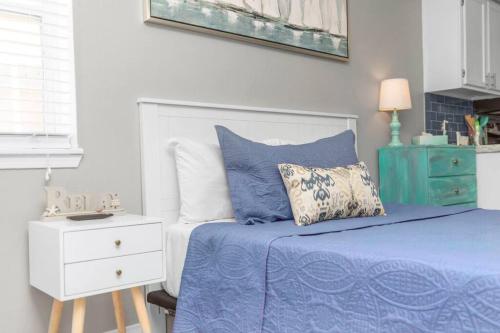 a bedroom with a blue bed and a white dresser at Our Happy Place in Fort Walton Beach