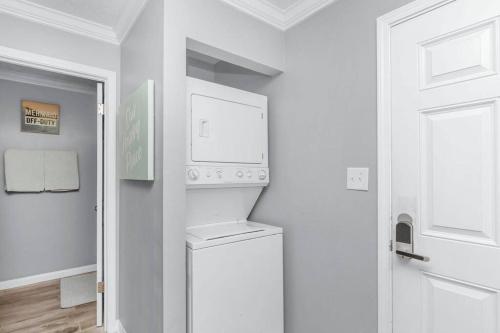 a white laundry room with a washer and dryer at Our Happy Place in Fort Walton Beach