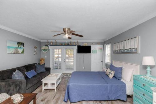 a living room with a blue bed and a couch at Our Happy Place in Fort Walton Beach