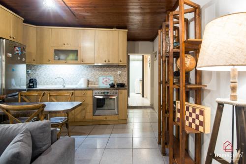 a kitchen with wooden cabinets and a table in a room at Sea Side House in Nea Chili