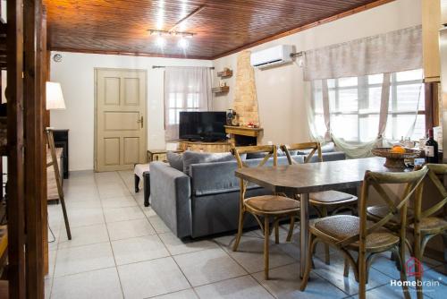 a living room with a table and a couch at Sea Side House in Nea Chili