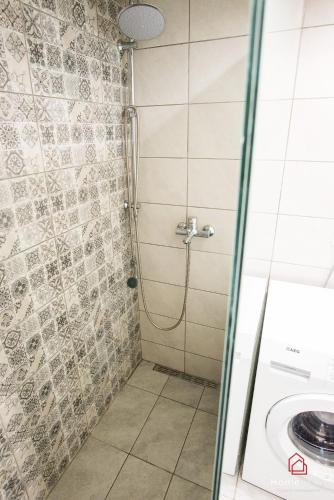 a shower with a glass door next to a sink at Sea Side House in Nea Chili