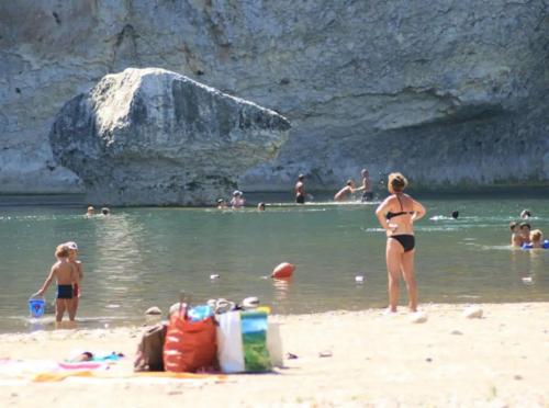 a group of people in the water at a beach at MAISON DE VACANCES CLIMATISEE "Le Nid de Saint Martin" in Saint-Martin-dʼArdèche