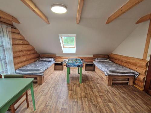a room with two beds and a table in it at Relax Srub Kunějov in Hosterschlag