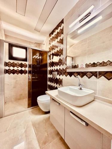 a bathroom with a sink and a toilet at Villa Bella in Kuşadası