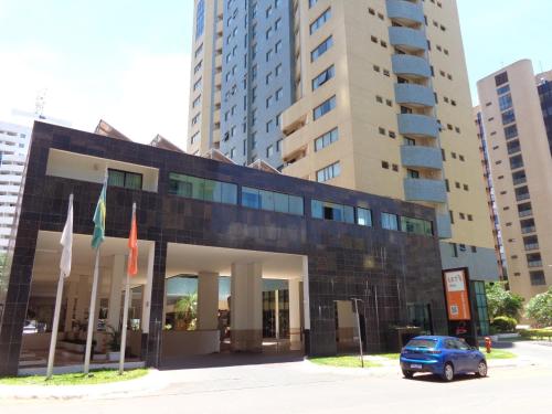 a blue car parked in front of a building at Hotel Lets Idea Flat Particular in Brasilia