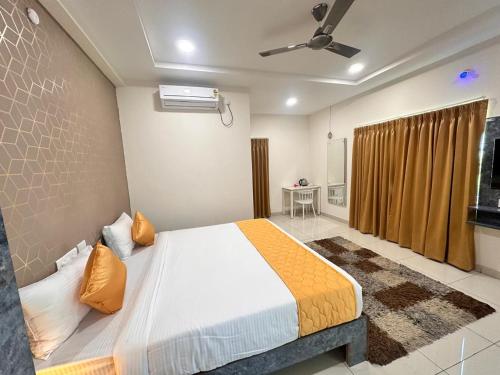 a bedroom with a large bed in a room at Hotel Aerotel,Hyderabad in Shamshabad