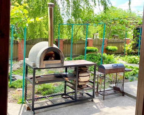 a outdoor oven with a table and a grill at ПростоРа in Khalepʼye