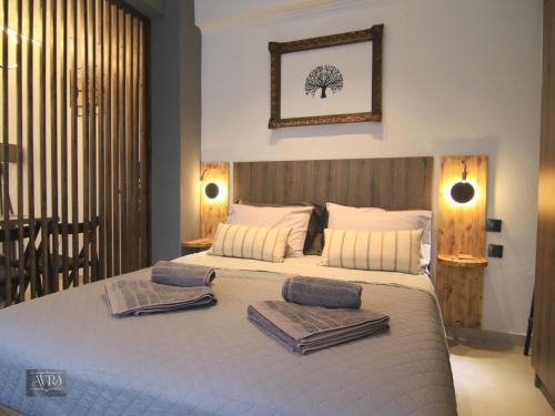 a bedroom with a large bed with towels on it at Avra Studio Kastoria in Kastoria