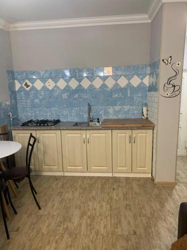 a kitchen with a sink and a counter top at Cherqe Guest House in Sighnaghi