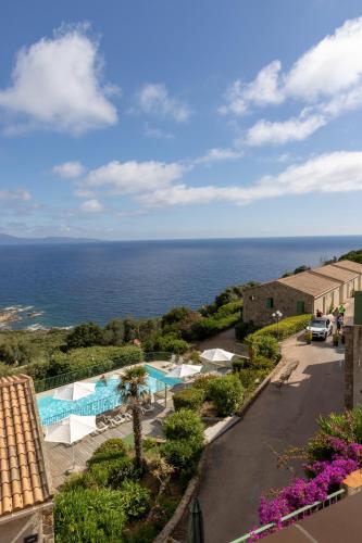a view of the ocean from the balcony of a resort at Residence Roc E Mare Cargèse in Cargèse